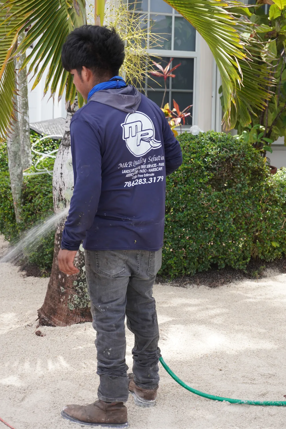 M&R Outdoor Living crew watering fresh plantings