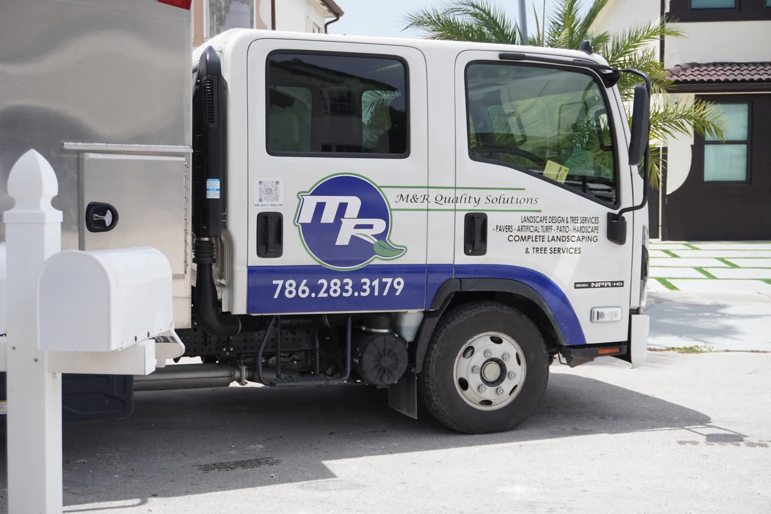 M&R Outdoor Living service truck on a South Florida job site