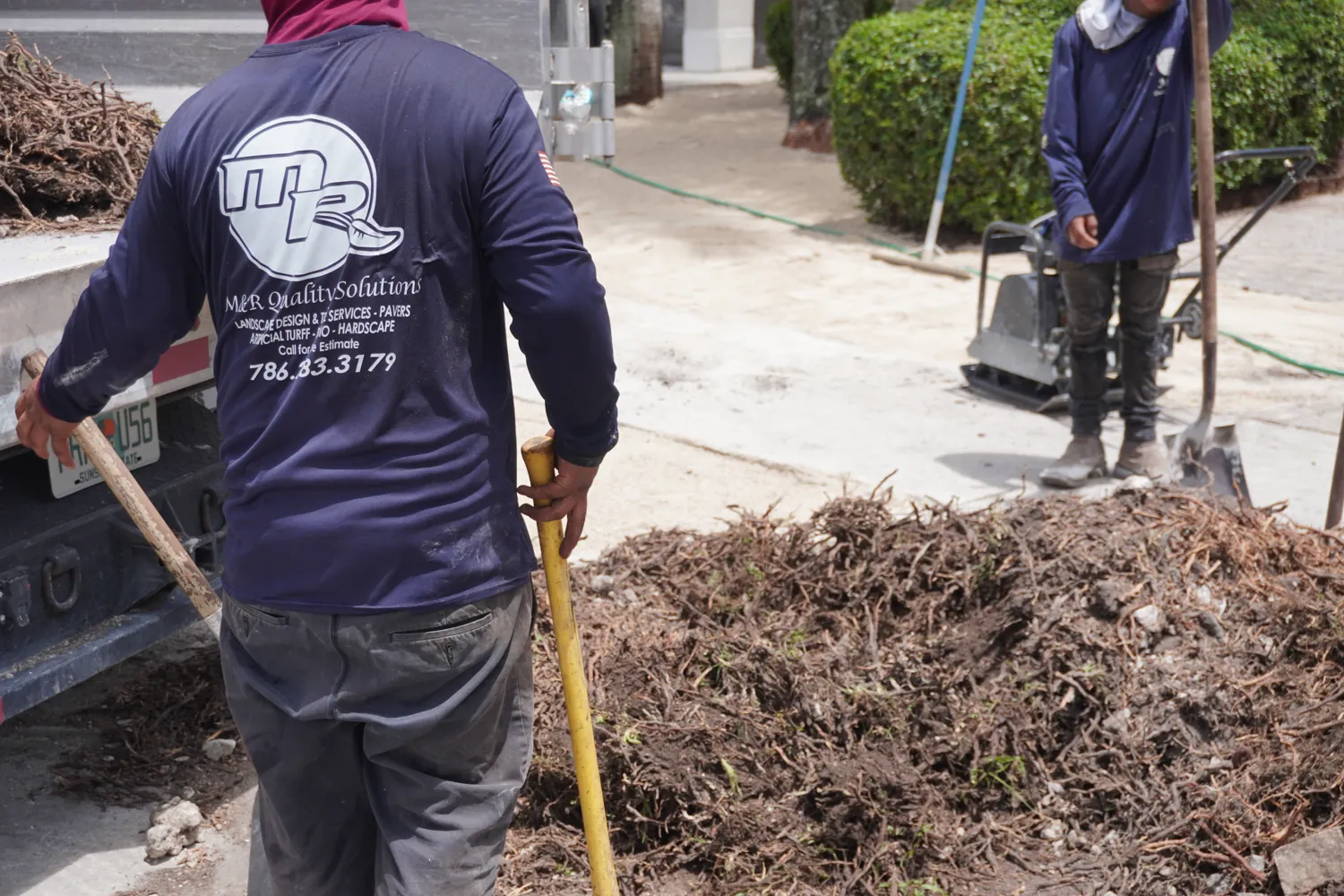 M&R Outdoor Living crew clearing and hauling mulch