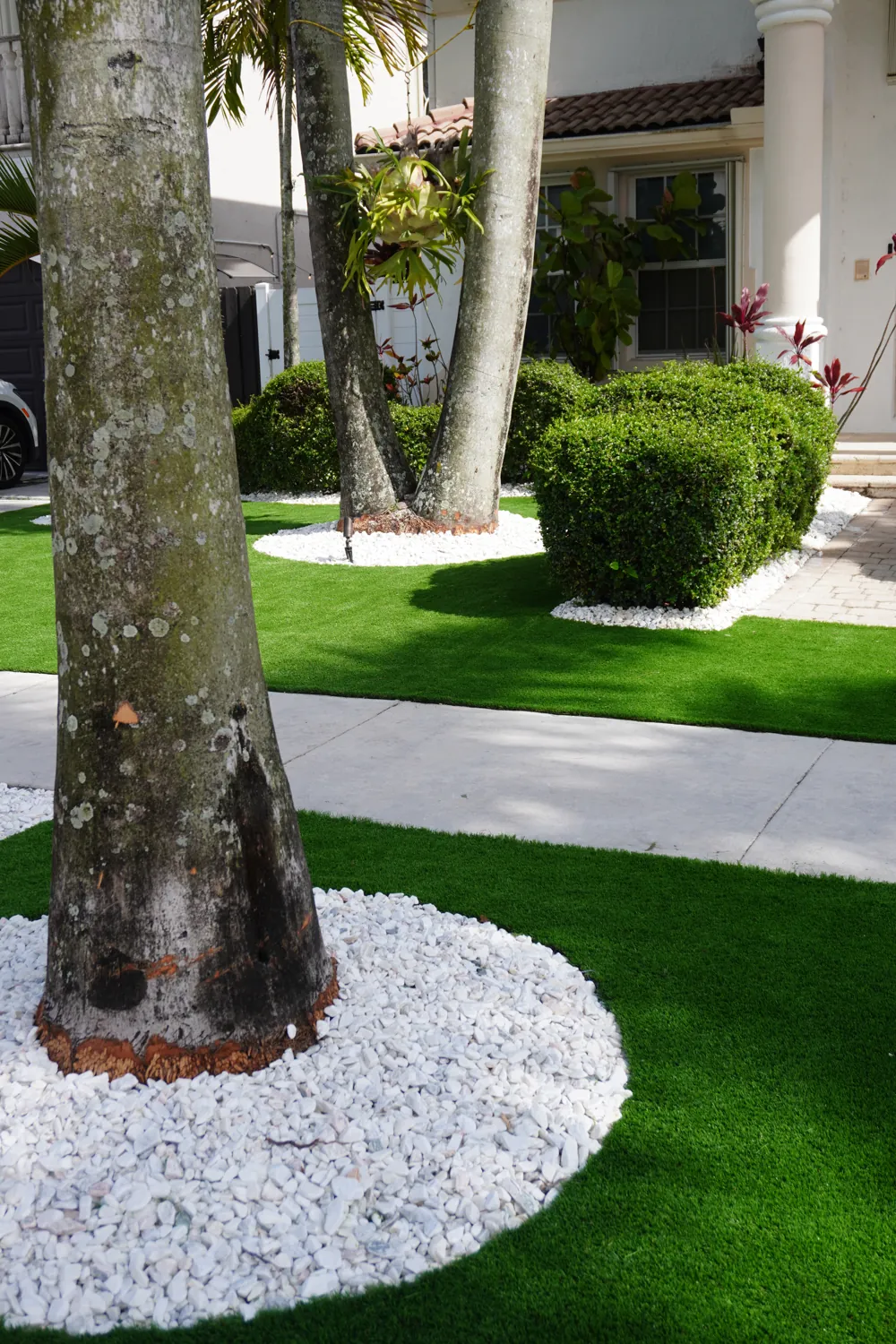 Manicured artificial turf lawn and tropical hedges at a South Florida home