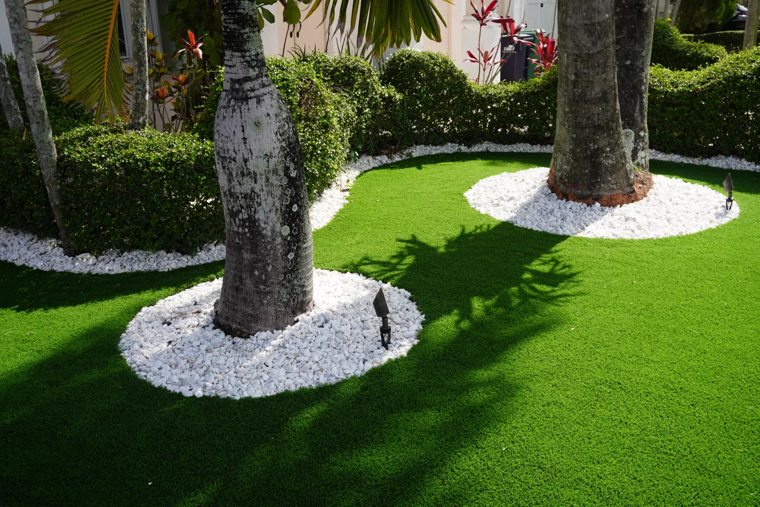 Green artificial turf and paver walkway in front of a South Florida home